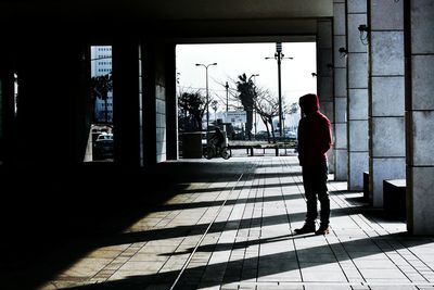 Full length of man standing on pavement