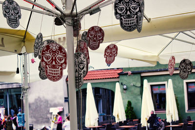 Low angle view of lanterns hanging by building