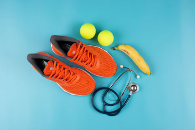 High angle view of fruits on table against blue background