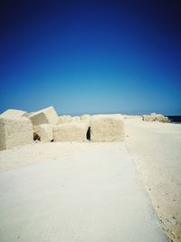 View of beach against clear blue sky