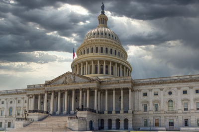 Low angle view of building against cloudy sky