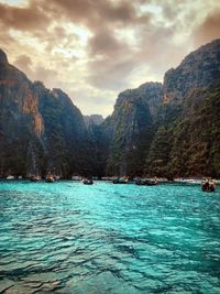 Scenic view of sea and mountains against sky