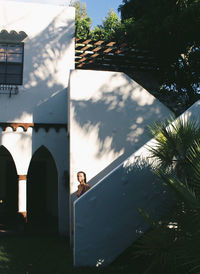Reflection of man standing on palm tree