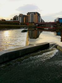 River in city against sky