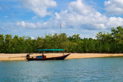 Boat in river against sky