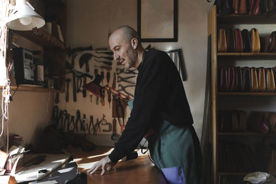 Man cutting textile in atelier