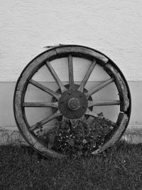 Close-up of rusty wheel on field