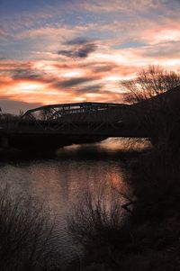 Scenic view of river against sky at sunset