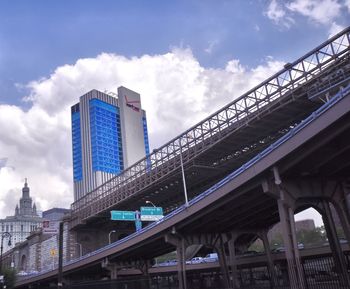 Low angle view of bridge against sky in city