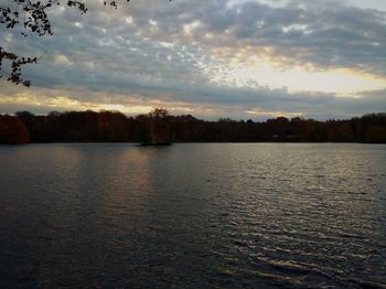 Scenic view of lake against sky at sunset