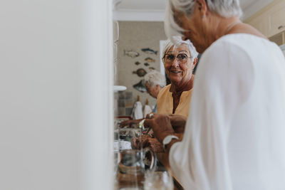 Smiling senior women talking at home