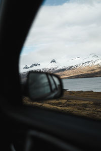 View of sea seen through car windshield