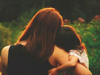 Rear view of mother and daughter