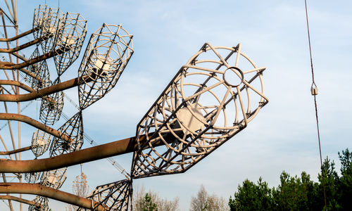 Low angle view of communications tower against sky