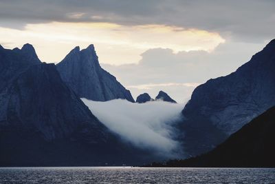 Panoramic view of sea and mountains against sky during sunset