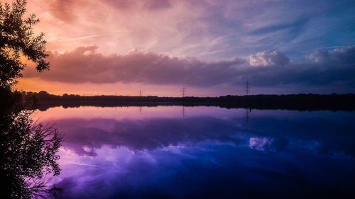 Scenic view of lake against sky at sunset