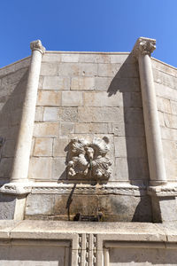 Low angle view of statue against building