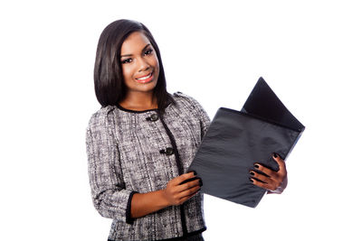 Portrait of young woman against white background