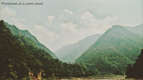 Panoramic shot of countryside landscape against mountain range