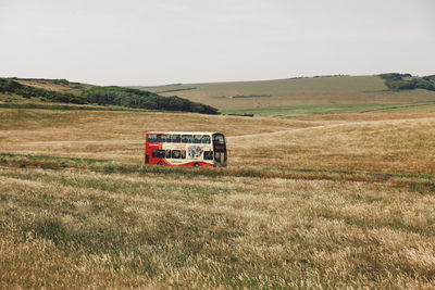 Scenic view of grassy field against sky