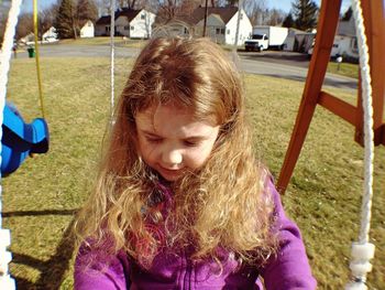 Girl enjoying on swing at playground