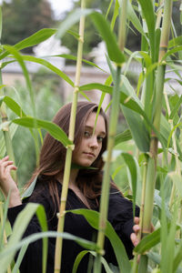 Portrait of woman with plants in field