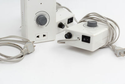 High angle view of camera on table against white background