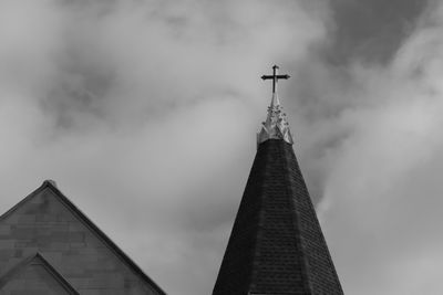 Low angle view of building against cloudy sky