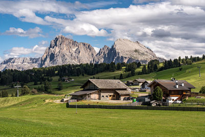 Houses on field against sky