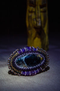 Close-up of crystal ball on table against black background