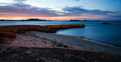 Scenic view of the bay of roscoff and the island of batz at sunset