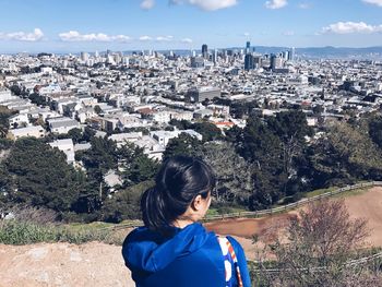 Rear view of boy on landscape against sky