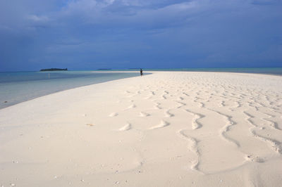 Scenic view of beach against blue sky