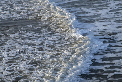 High angle view of waves rushing towards shore