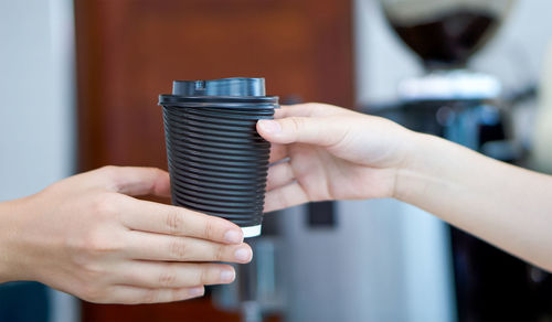 Close-up of people holding metal