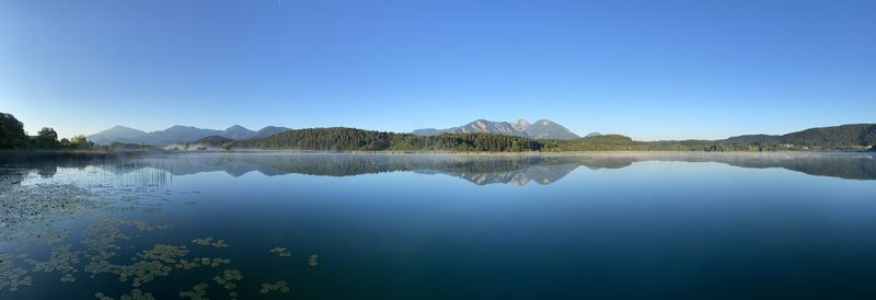 Scenic view of lake against clear blue sky