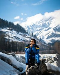 Full length of woman on snowcapped mountains against sky