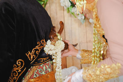 Close-up of woman holding flower bouquet