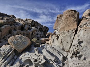 Low angle view of rocks on beach against sky