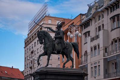 Low angle view of statue against building