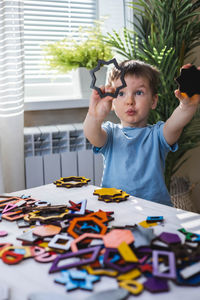 Cute boy playing with toys at home