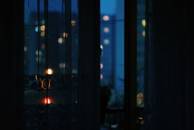 Close-up of illuminated lamp on window