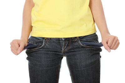 Low section of woman standing against white background