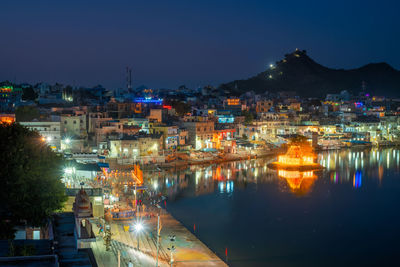 High angle view of illuminated buildings in city at night