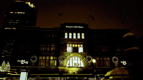 Low angle view of buildings against sky at night