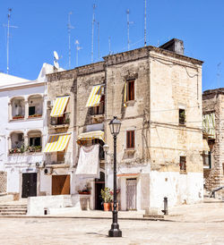 Old building against clear blue sky in city