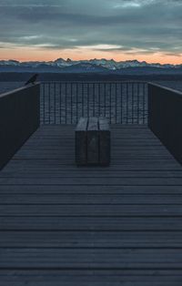 View of sea against mountain range sky during sunset