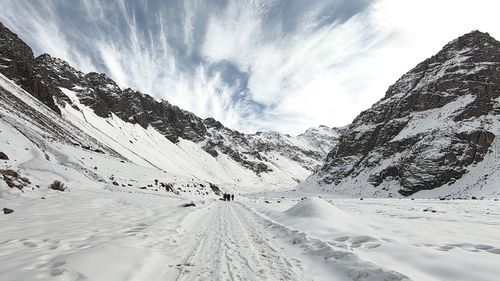 Scenic view of snow covered mountains against sky