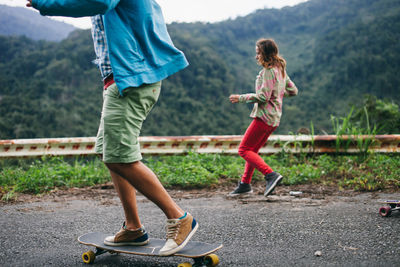 Low section of girl standing on road