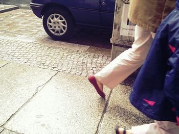 Close-up of young woman standing against wall